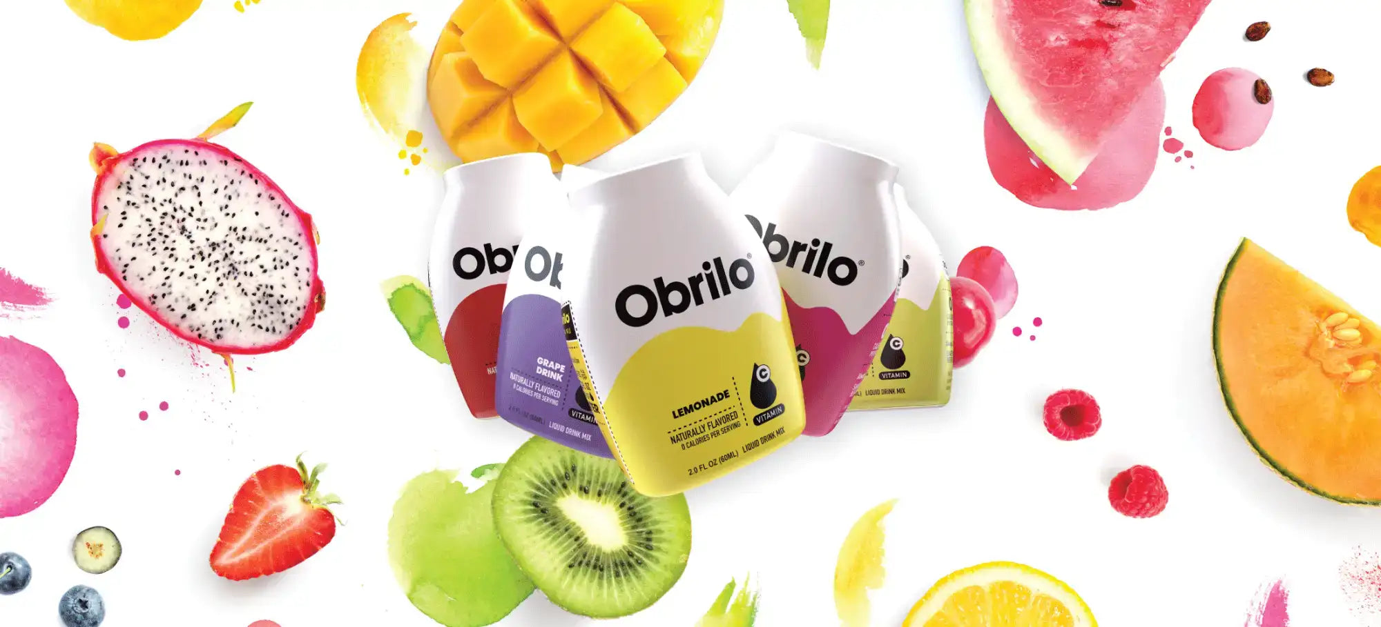 Three obrilo drink bottles, each with a distinct colored label—red, purple, and yellow—and white caps, surrounded by vibrant fruit slices.